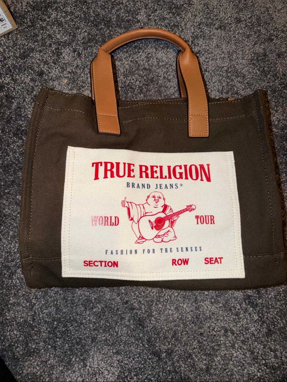 True Religion Brown Canvas Tote with Tan Leather Handles and Red Logo Patch